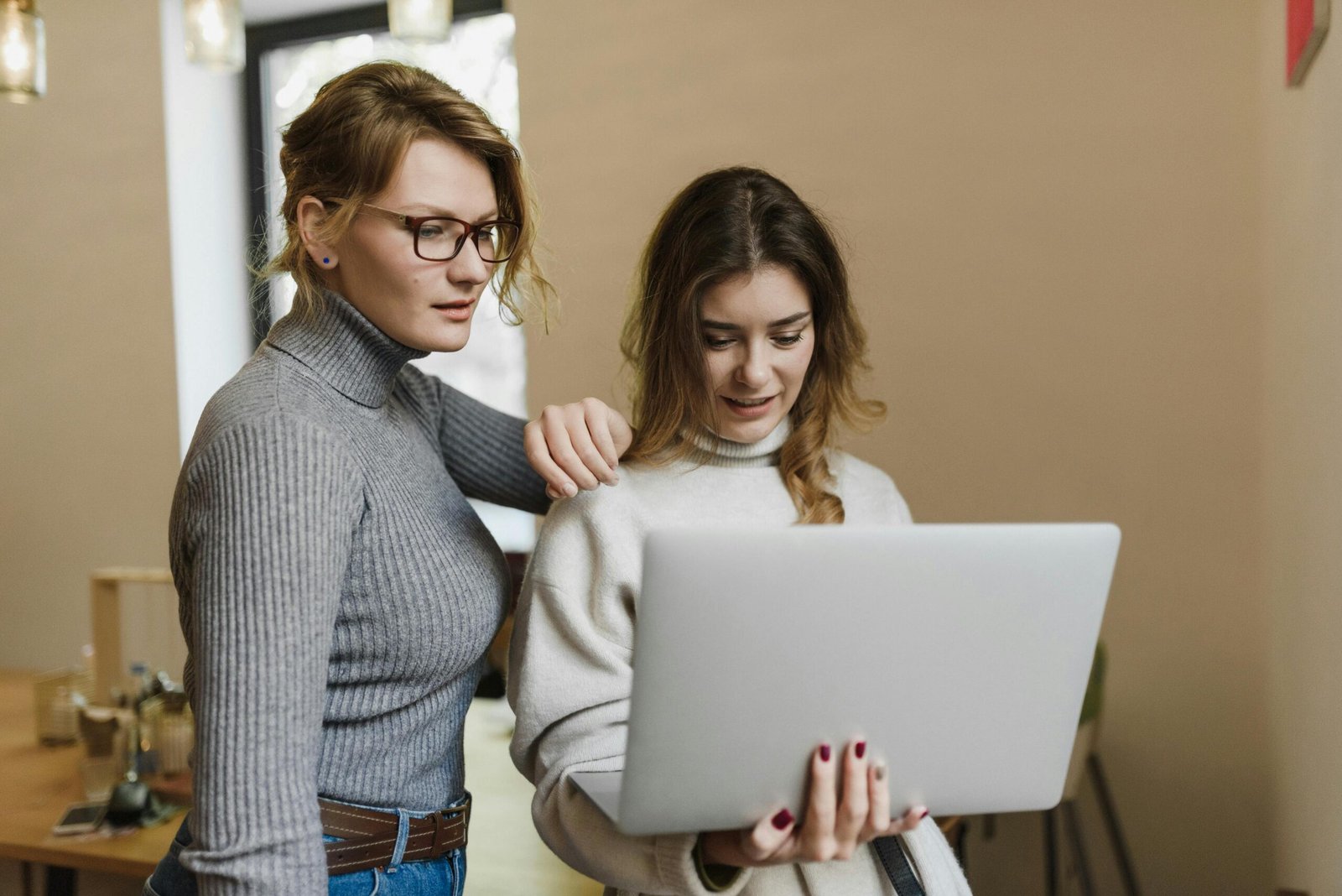 Support worker and client with laptop